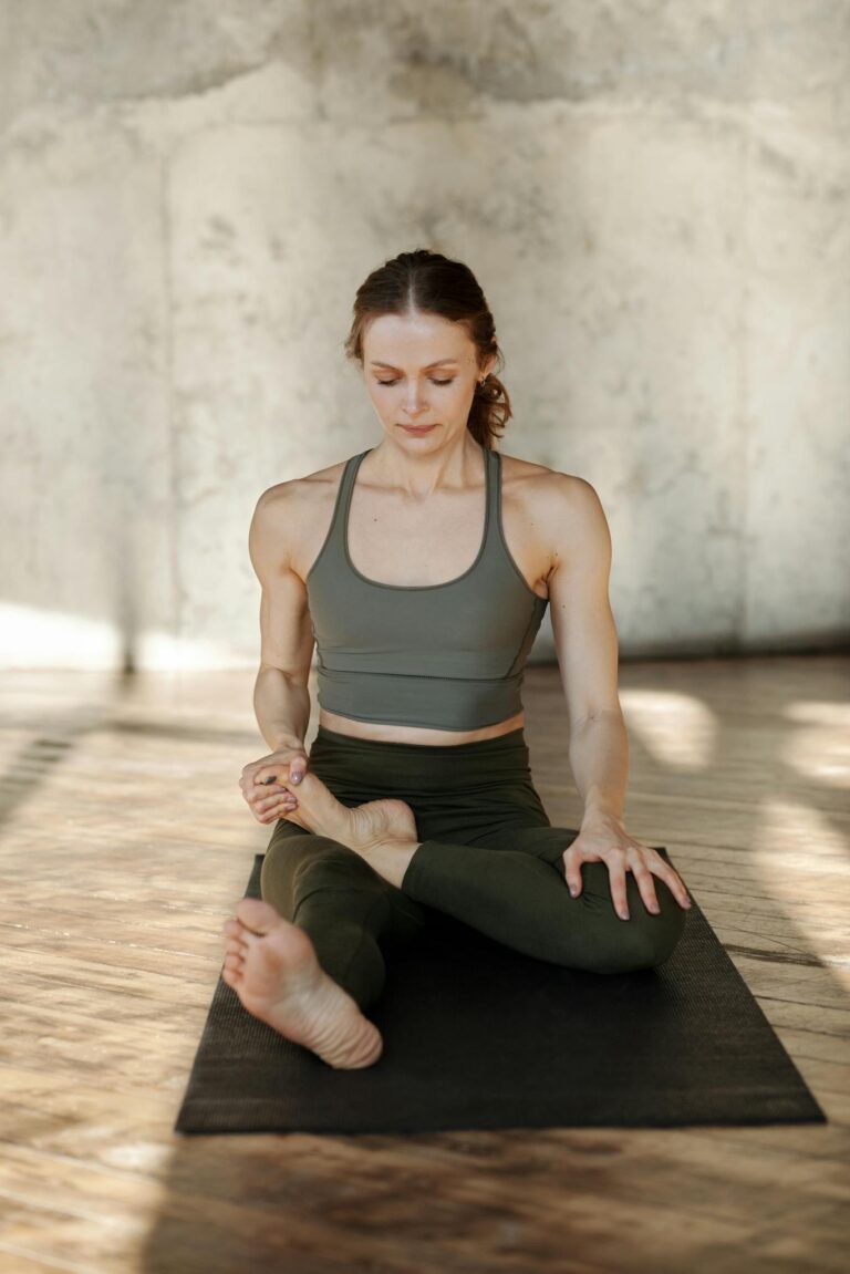 Young woman in yoga pose, embracing wellness in a calm indoor environment.